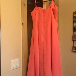 Pink dress with bow in the front. Longer knee dress.